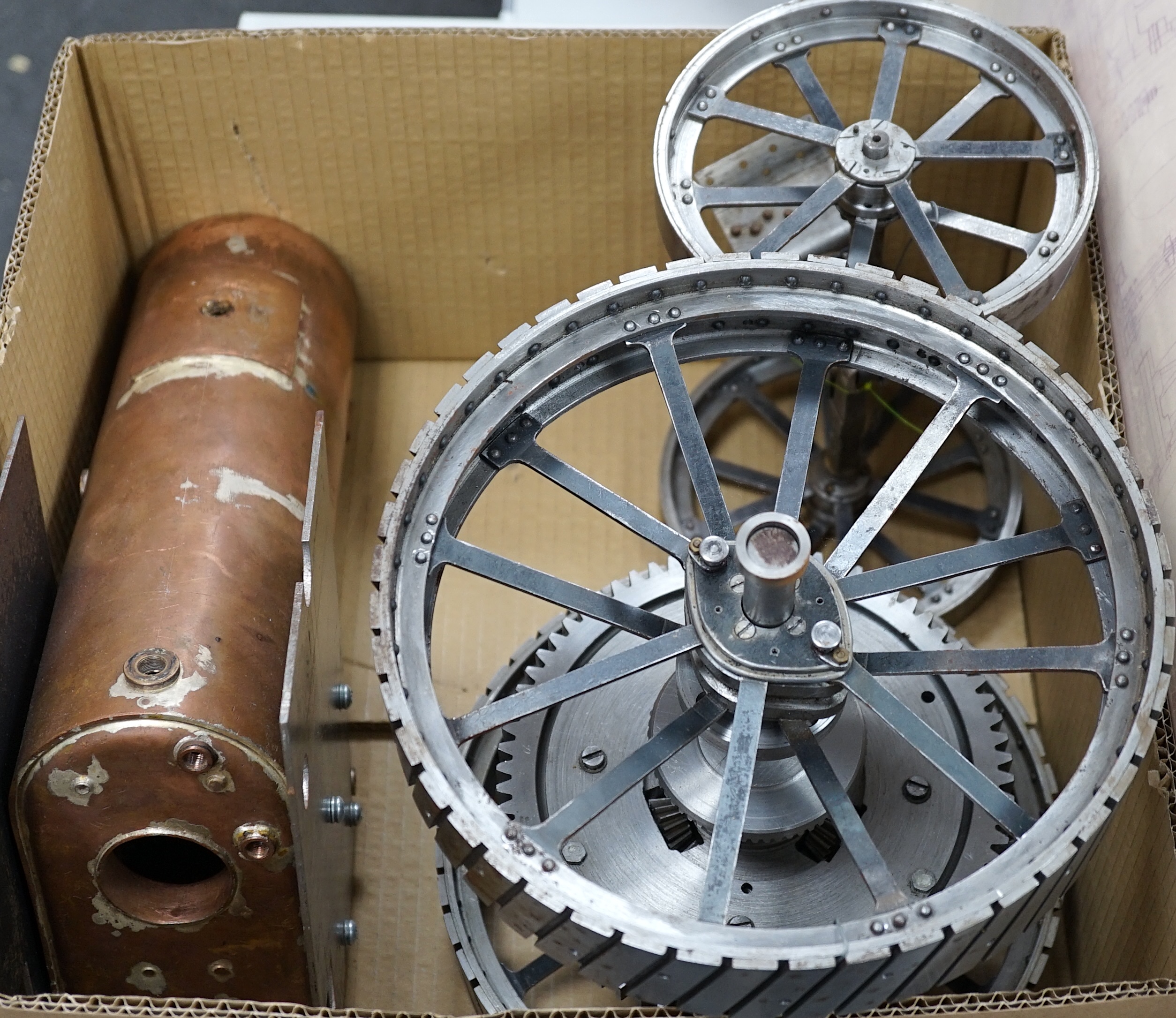 A partially constructed kit comprising of the major components of machined and cast parts to build a two inch scale live steam Ransomes 4 N.H.P. traction engine, including a set of drawings